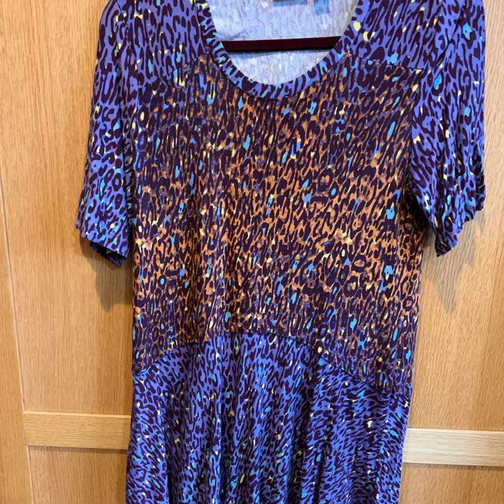 Logo Peplum purple short sleeve top, size M.